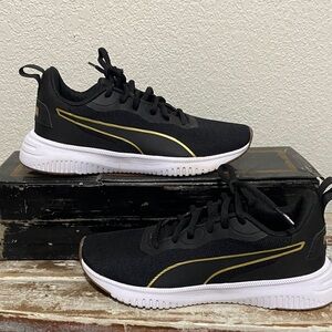 Kids black with gold stripes puma sneakers 👟 Almost new …worn 1 time.